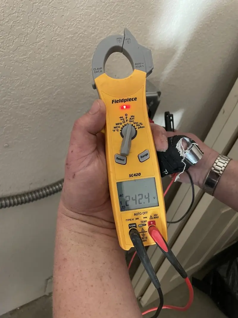 Voltage testing with clamp meter during Recessed Lighting Installation in Mattoon